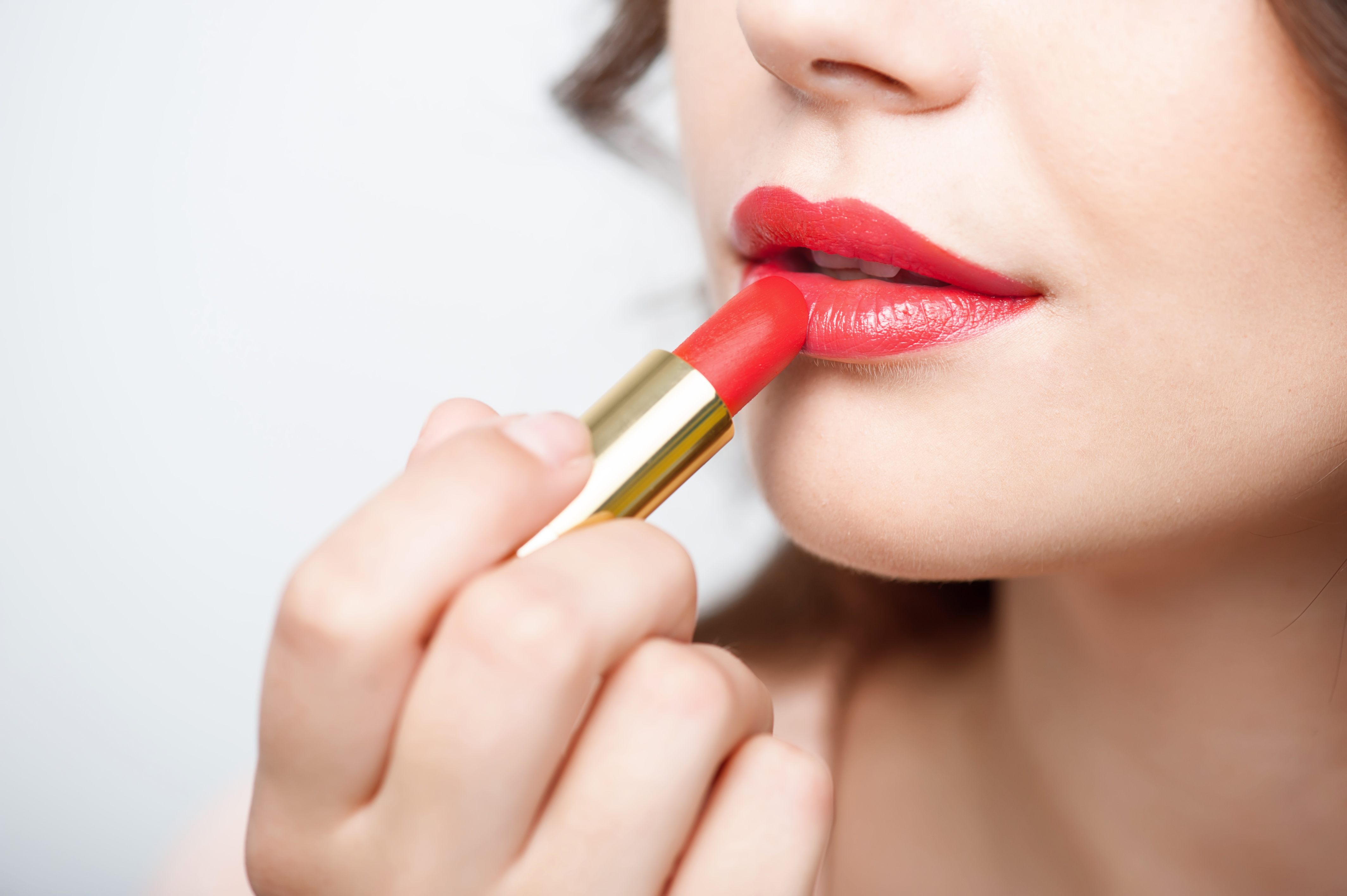 Woman applying lipstick